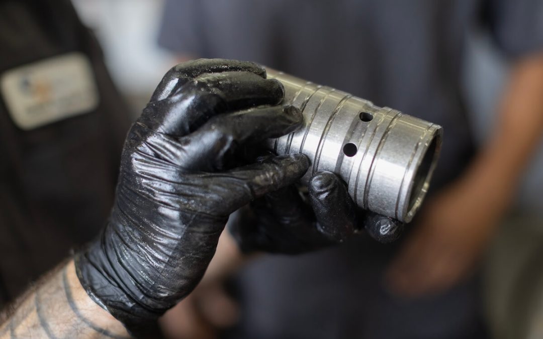 expert checking hydraulic cylinder leaks